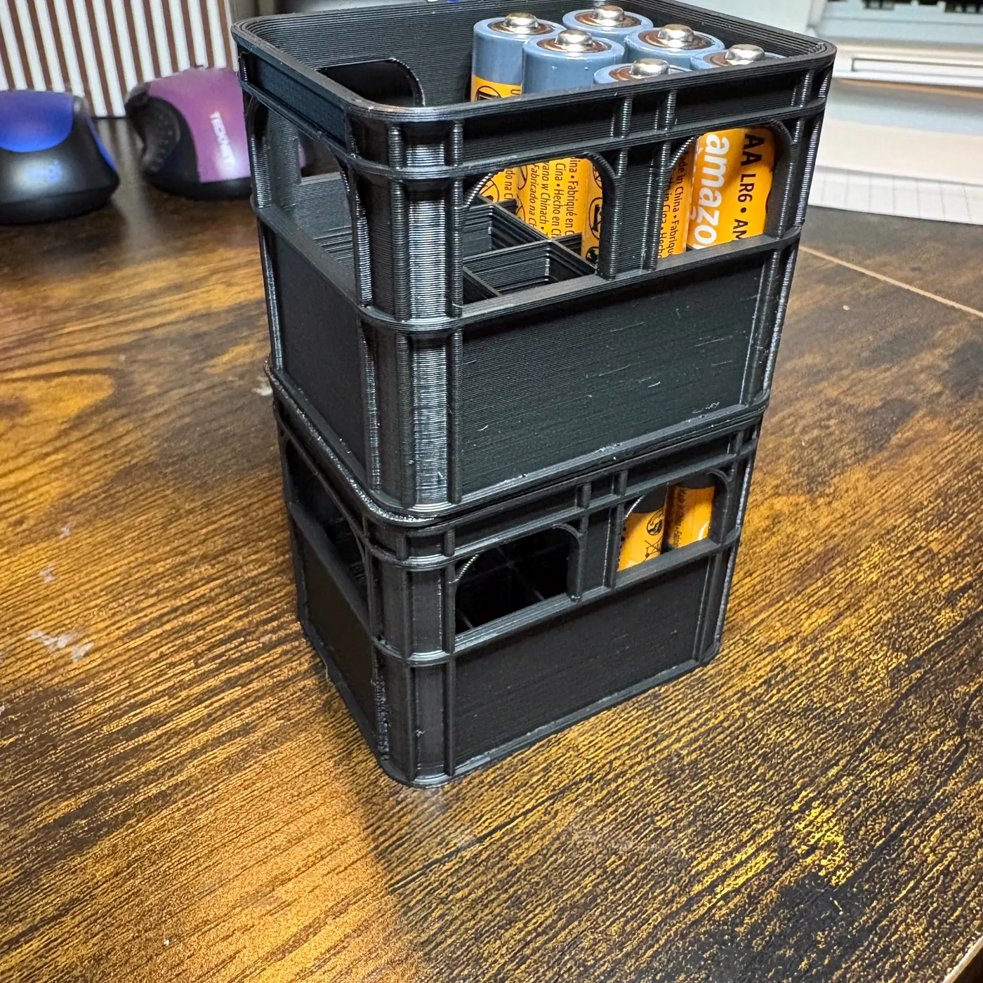 Two stacked black battery crates holding batteries